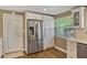 Kitchen featuring stainless steel refrigerator, white cabinets, and a door to the outside at 198 Salem Nw Ave, Port Charlotte, FL 33952