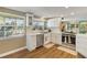 Updated kitchen showcases new stainless steel appliances, white cabinets, and wood flooring at 198 Salem Nw Ave, Port Charlotte, FL 33952