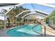 Enclosed pool area with seating, outdoor kitchen, and well-maintained landscaping provides private oasis at 198 Salem Nw Ave, Port Charlotte, FL 33952