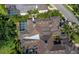 Aerial view of the house showing the roof, screened pool and green landscaping at 2065 Harbour Links Dr # 5, Longboat Key, FL 34228