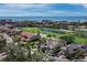 Aerial view showcasing the tan-roofed house near a golf course, lake and ocean with city views at 2065 Harbour Links Dr # 5, Longboat Key, FL 34228