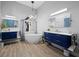 Modern bathroom with dual vanities, a freestanding tub, and luxury lighting at 2065 Harbour Links Dr # 5, Longboat Key, FL 34228