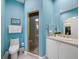 Cozy blue bathroom with a glass shower and white vanity at 2065 Harbour Links Dr # 5, Longboat Key, FL 34228