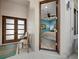 View of a bedroom through a doorway, featuring blue walls, wood floors, and modern decor at 2065 Harbour Links Dr # 5, Longboat Key, FL 34228