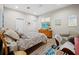 Bright bedroom with a ceiling fan, a TV on the dresser, and a comfortable armchair at 2065 Harbour Links Dr # 5, Longboat Key, FL 34228