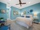 Stylish bedroom featuring blue walls, wood floors, a ceiling fan, and modern decor at 2065 Harbour Links Dr # 5, Longboat Key, FL 34228