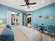 Light and airy bedroom with blue accent wall, light colored wood floors, and a patio view at 2065 Harbour Links Dr # 5, Longboat Key, FL 34228