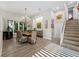 Well-lit dining room featuring a chandelier and staircase access at 2065 Harbour Links Dr # 5, Longboat Key, FL 34228