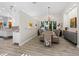 Open dining room with modern chandelier, wood floors, and bright natural light at 2065 Harbour Links Dr # 5, Longboat Key, FL 34228