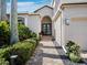Charming front entrance with a paved walkway, manicured hedges, and a beautifully landscaped yard at 2065 Harbour Links Dr # 5, Longboat Key, FL 34228