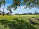 Scenic view of lush green golf course framed by palm trees and blue sky at 2065 Harbour Links Dr # 5, Longboat Key, FL 34228