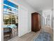 Hallway with views of the screened-in pool, lush landscaping and patio seating at 2065 Harbour Links Dr # 5, Longboat Key, FL 34228