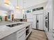 Modern kitchen with large island, bar seating, and lots of storage at 2065 Harbour Links Dr # 5, Longboat Key, FL 34228