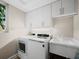 Bright laundry room featuring a washing machine, dryer, cabinets and a sink and lots of counter space at 2065 Harbour Links Dr # 5, Longboat Key, FL 34228
