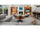 Spacious living room with fireplace, built-ins, bar seating, and sliding glass doors to the lanai at 2065 Harbour Links Dr # 5, Longboat Key, FL 34228