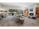 Open living room with a fireplace, modern furnishings, and a large sliding glass door to the lanai at 2065 Harbour Links Dr # 5, Longboat Key, FL 34228