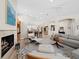 Bright, open living room with fireplace, wood floors, modern furniture, and golf course views at 2065 Harbour Links Dr # 5, Longboat Key, FL 34228