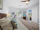 Bright main bedroom with shutters, fan and patio access to the pool at 2065 Harbour Links Dr # 5, Longboat Key, FL 34228