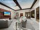 Covered patio with comfortable seating, a mounted TV, and ceiling fans for relaxing outdoor entertainment at 2065 Harbour Links Dr # 5, Longboat Key, FL 34228