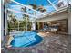 Covered pool and spa area with screened enclosure, outdoor seating, and scenic views at 2065 Harbour Links Dr # 5, Longboat Key, FL 34228
