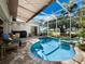 Inviting pool and spa area with covered seating, screened enclosure, and lush greenery at 2065 Harbour Links Dr # 5, Longboat Key, FL 34228