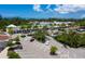 Aerial view of a shopping center parking lot surrounded by lush greenery and palm trees at 2065 Harbour Links Dr # 5, Longboat Key, FL 34228