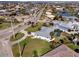 An aerial view of a property reveals lush landscaping, a screened pool, and convenient access to roadways at 2501 W Marion Ave, Punta Gorda, FL 33950