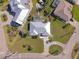 An overhead shot showing a home with a gray roof, green lawn, tropical landscaping and pool at 2501 W Marion Ave, Punta Gorda, FL 33950