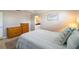 Well-lit bedroom with a comfortable bed and beach-themed wall decor at 2501 W Marion Ave, Punta Gorda, FL 33950