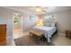 Relaxing bedroom featuring a comfortable bed, natural light, and beach-themed decor at 2501 W Marion Ave, Punta Gorda, FL 33950
