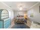 Comfortable bedroom featuring tile floors, large windows and fun beach themed furniture and textiles at 2501 W Marion Ave, Punta Gorda, FL 33950