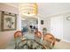 A dining room features a glass table, rattan chairs and a woven pendant light fixture at 2501 W Marion Ave, Punta Gorda, FL 33950