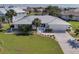 Beautiful waterfront property featuring a metal roof, well-manicured lawn, and a two car garage at 2501 W Marion Ave, Punta Gorda, FL 33950