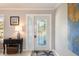Inviting front entrance with decorative glass door, side panel window and tile flooring at 2501 W Marion Ave, Punta Gorda, FL 33950