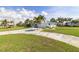Charming single-story home featuring a well-manicured lawn, a lengthy driveway, and complemented by swaying palm trees at 2501 W Marion Ave, Punta Gorda, FL 33950