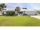 Charming single-story home with a well-manicured lawn and a white metal roof at 2501 W Marion Ave, Punta Gorda, FL 33950