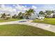 Charming single-story home featuring a well-manicured lawn, a lengthy driveway, and complemented by swaying palm trees at 2501 W Marion Ave, Punta Gorda, FL 33950