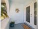 Inviting front porch with decorative accents and an arched entryway with a view of a palm tree at 2501 W Marion Ave, Punta Gorda, FL 33950