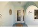 Welcoming front entrance with decorative glass door and arched stucco architecture at 2501 W Marion Ave, Punta Gorda, FL 33950