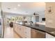 Open concept kitchen with a large island, white cabinetry, granite countertops, and views to the living room at 2501 W Marion Ave, Punta Gorda, FL 33950