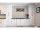 Kitchen area featuring white cabinets with stainless steel hardware, granite countertops, and a decorative painting at 2501 W Marion Ave, Punta Gorda, FL 33950
