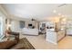Bright open-concept living room with tile floors, a comfortable sofa, and views of the kitchen and outdoor patio at 2501 W Marion Ave, Punta Gorda, FL 33950