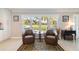 Inviting living room featuring two leather chairs, a decorative rug, and a large bright window with a view at 2501 W Marion Ave, Punta Gorda, FL 33950