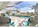 Relaxing screened-in pool area with lounge chairs and a clear view of the canal at 2501 W Marion Ave, Punta Gorda, FL 33950