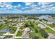 Aerial view showcasing the community, surrounding waterways, and lush landscaping at 26052 Salonika Ln, Punta Gorda, FL 33983