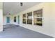 Covered back porch with large windows looking into a beautifully lit interior space at 26052 Salonika Ln, Punta Gorda, FL 33983