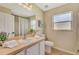 Bright bathroom featuring a large mirror, neutral walls, and a shower with a striped curtain at 26052 Salonika Ln, Punta Gorda, FL 33983
