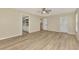 Bedroom with wood flooring and access to a bathroom, closet and a glass door to the backyard at 26052 Salonika Ln, Punta Gorda, FL 33983