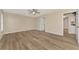 Large bedroom features wood flooring, a ceiling fan and access to an ensuite bathroom and kitchen at 26052 Salonika Ln, Punta Gorda, FL 33983
