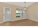 Dining room with tile flooring and decorative glass door offers views of the landscaped yard at 26052 Salonika Ln, Punta Gorda, FL 33983